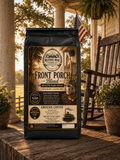 Front Porch Blend whole bean coffee bag on southern front porch with rocking chair and cotton field view, medium dark roast Ruthie Mae Coffee Co.